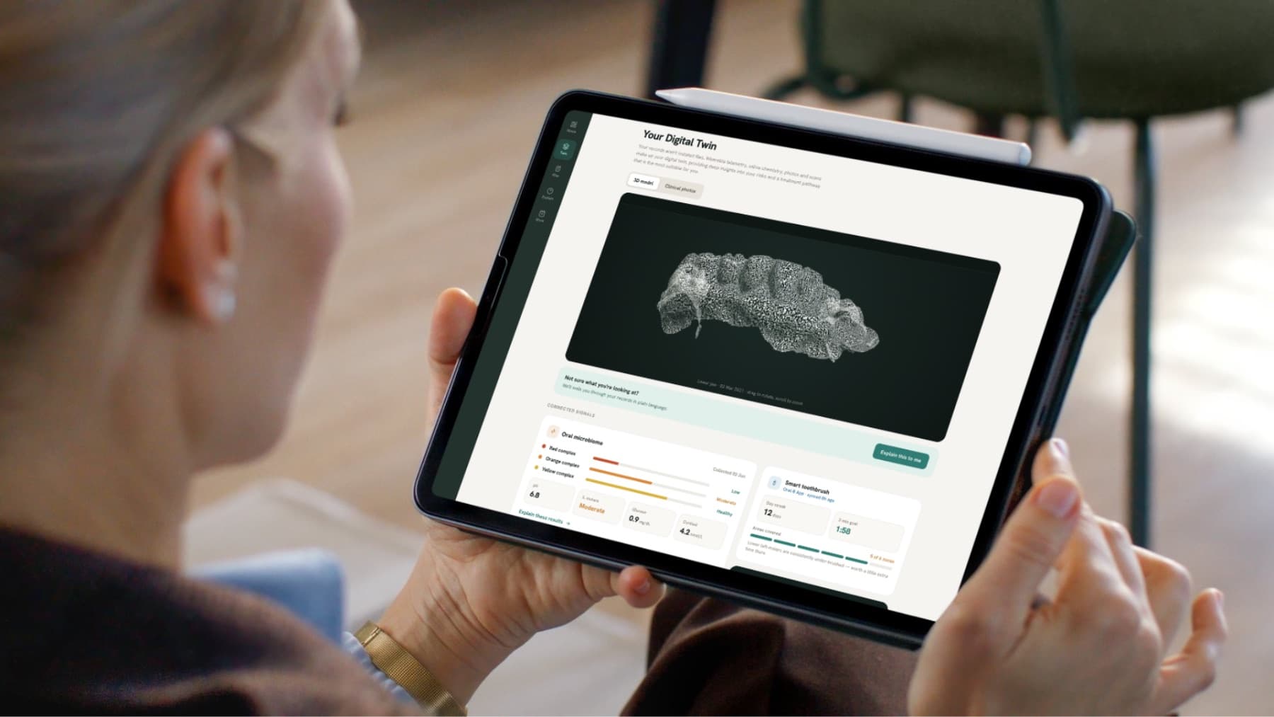 A patient viewing her 3D digital twin, a model of her teeth and gums, on a tablet