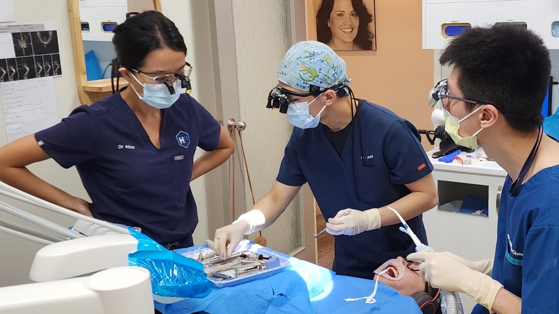 View photograph 3 of 7: Dr Alice Whang supervising a dentist during implant surgery