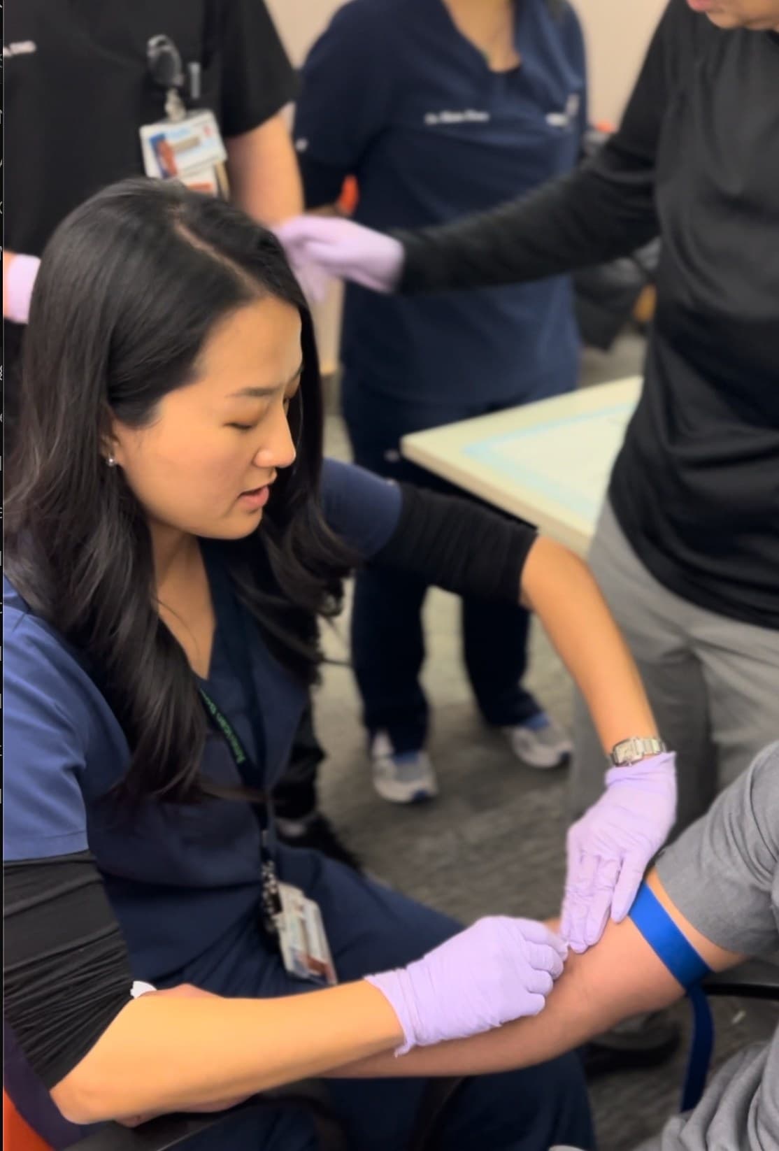 View photograph 6 of 7: Dr Alice Whang demonstrating a clinical technique as participants watch